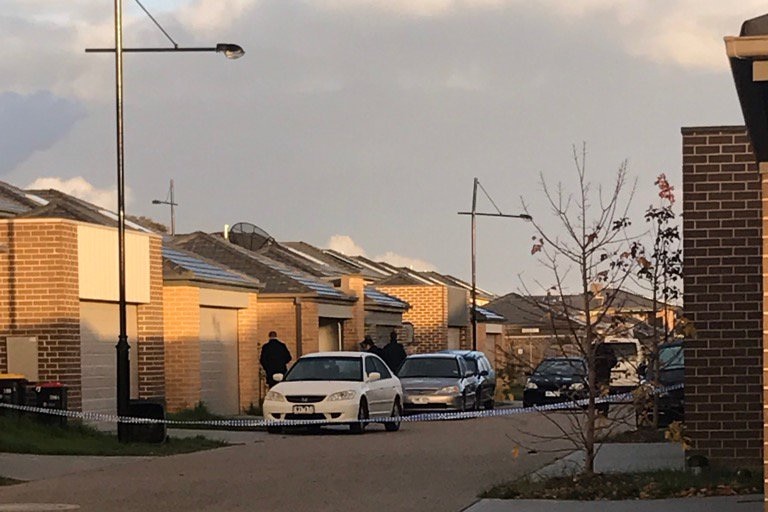 Police attend the scene where a man died and two others were injured in a shooting in Keysborough.