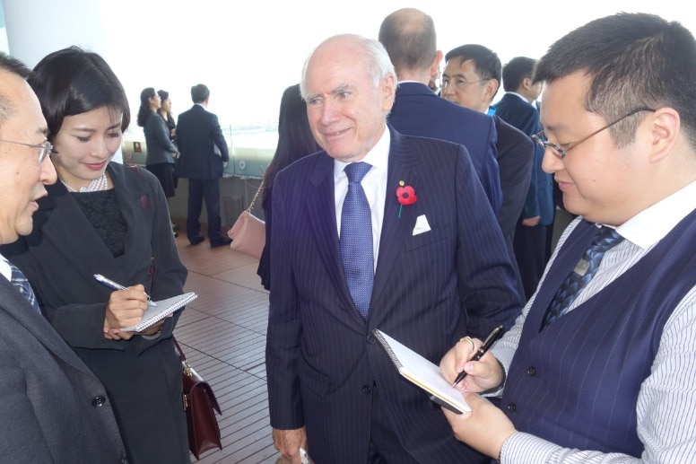 Interpreter John Zhou (right) with former Prime Minister John Howard.