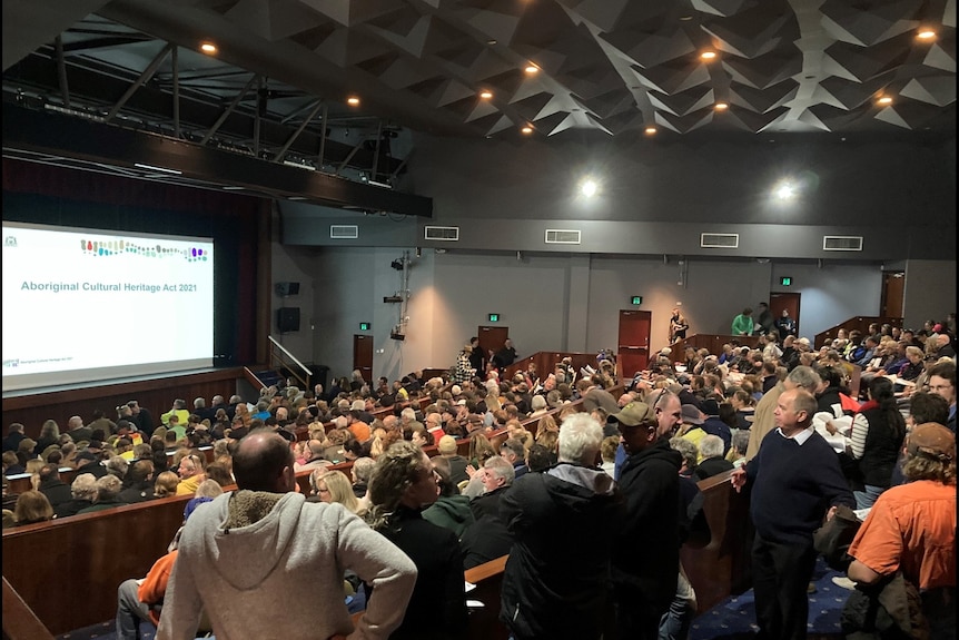 a crowd of people in a auditorium 