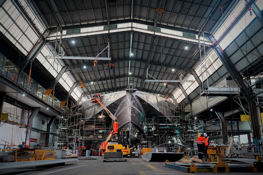 Construction underway at a catamaran factory.