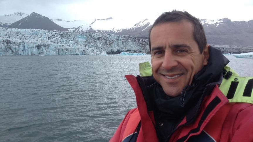Peter de Mouilpied pictured in front of glaciers wearing a winter jacket