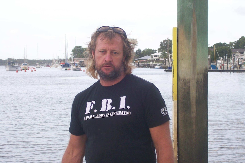 Stephen Armitage poses in a shirt that says 'Female Body Investigator'