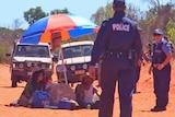 Protesters sit in the middle of a road as police try to move them on at James Price Point 2 August, 2012