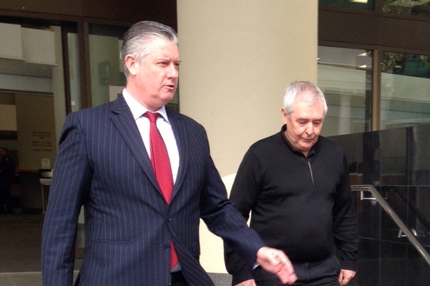 Ian Stuart McAlpine (R) with his lawyer Mark Andrews walks down steps outside a court building in Perth.