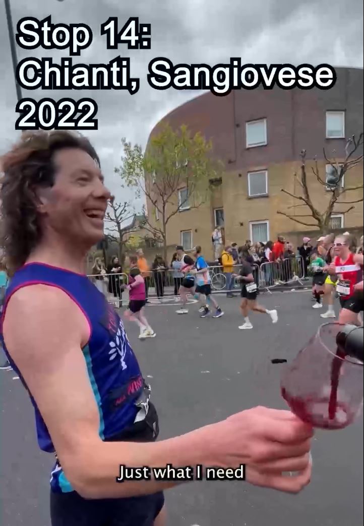 Screenshot of a man in running outfit on a during a race being poured a glass of red wine