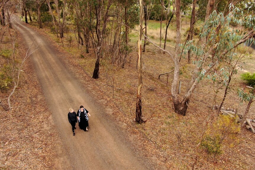 Heidi and her daughter Emma walk along the road near their rural property in Bendigo.
