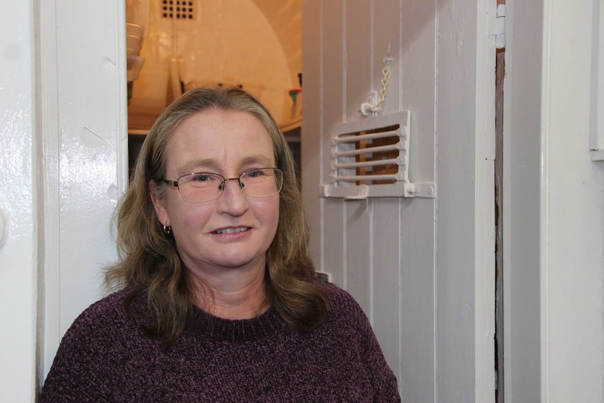 Amanda Taylor in front of old cell door.