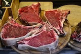 Four nice juicy red meat steaks completely raw.