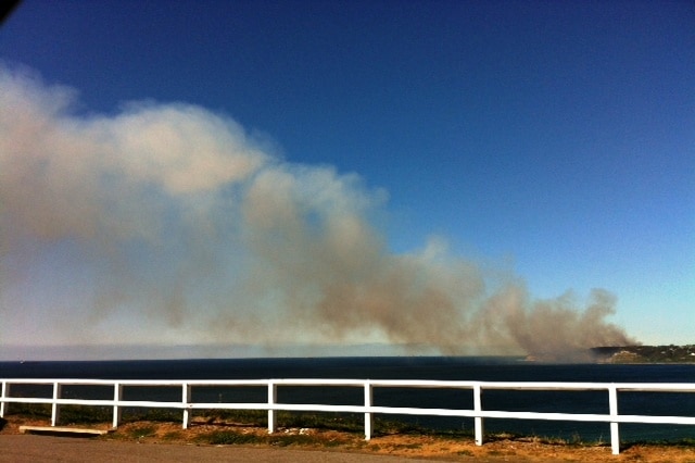 Smoke billows from the fire burning in inaccessible bush at Dudley.