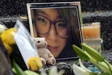 Flowers around a framed photo of 22-year-old student Eunji Ban, who was killed in Brisbane's CBD.