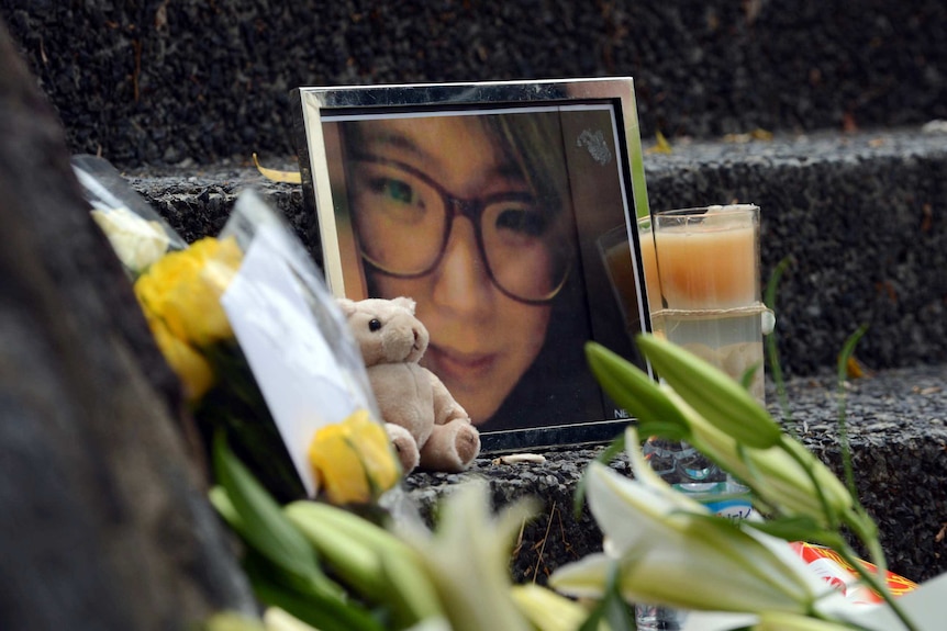 Flowers placed around a framed photo of Eunji Ban, who was killed in 2013.
