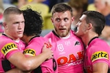Four Penrith Panthers NRL players embrace as they celebrate a try against the North Queensland Cowboys.