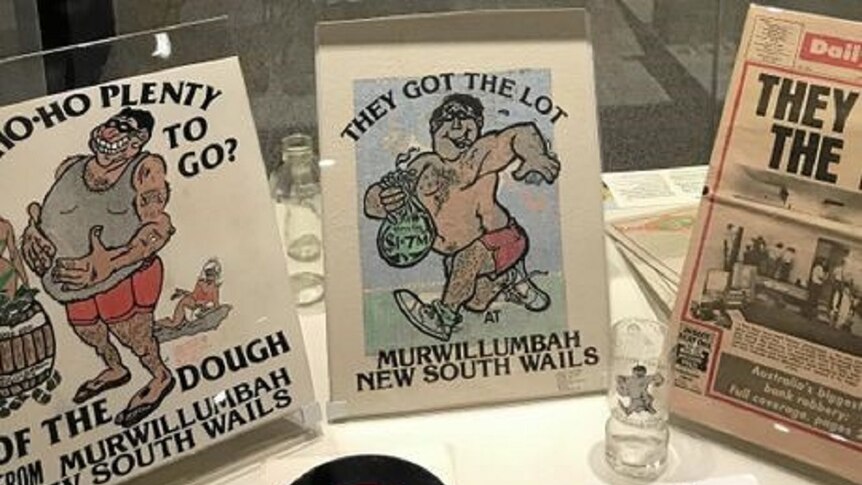 A display of T-shirts and a beer glass with the slogan "They Got the Lot" and a cartoon picture of a criminal running away