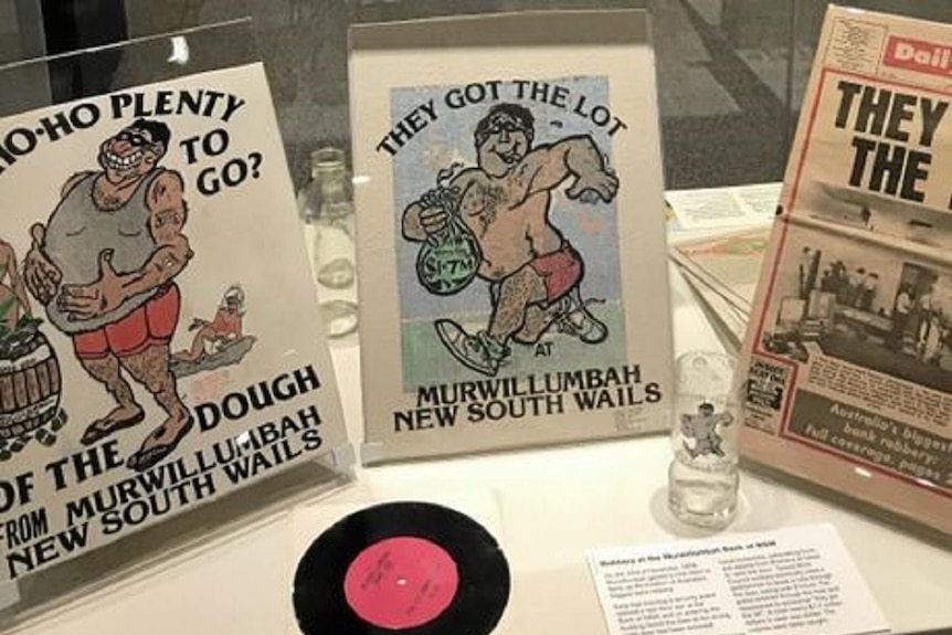 A display of T-shirts and a beer glass with the slogan "They Got the Lot" and a cartoon picture of a criminal running away