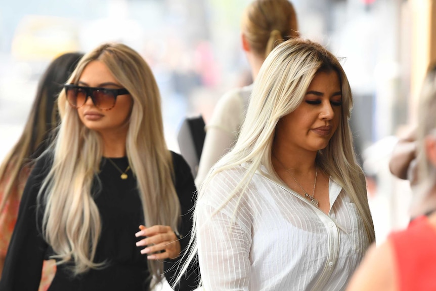 Shanae Pericic (left) wearing sunglasses and Brittany McGuire (right) arrive at the Melbourne Magistrates Court.