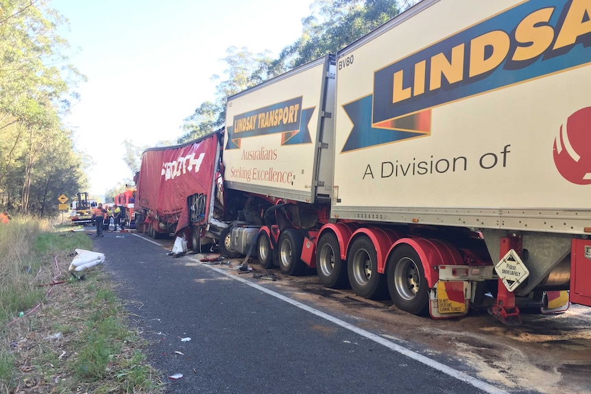 Two trucks crashed on a highway with emergency services workers