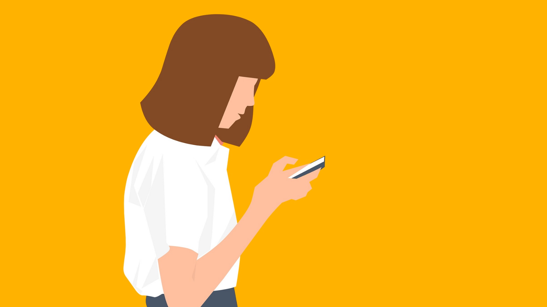 A woman looks down at a mobile phone.