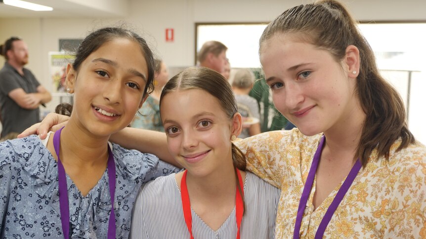 Three young girls at the first town hall meeting for youth council in Mackay. 