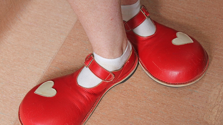 Clown doctor's oversized red shoes with white love hearts