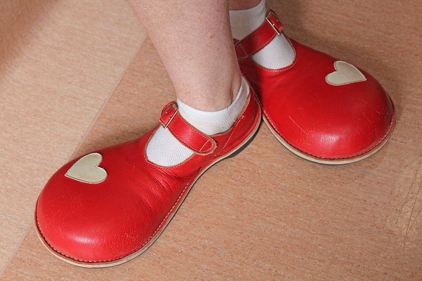 Clown doctor's oversized red shoes with white love hearts