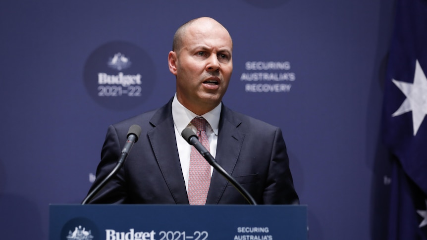 Josh Frydenberg speaks at a press conference with budget 2021-22 written behind him