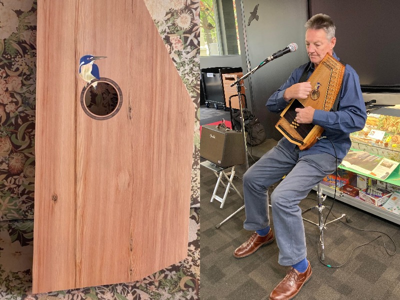 A man plays a wooden autoharp and a close-up of the wooden instrument with a picture of a kingfisher.