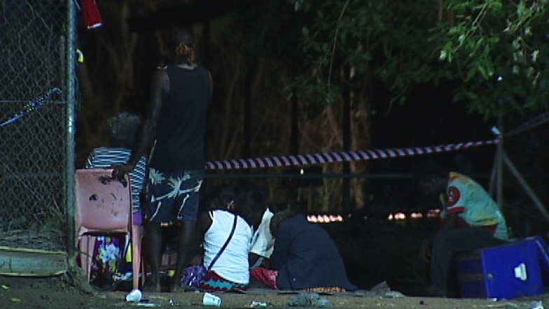 People at the scene of the fatal house fire in Darwin.