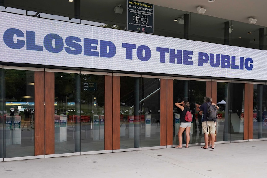 A sign reading "closed to public" is seen outside the MCG.