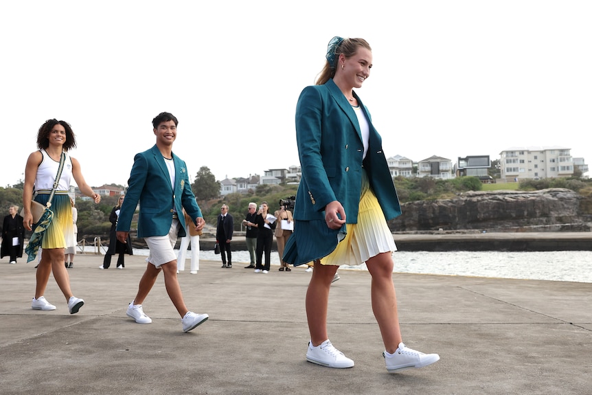Tilly Kearns and other Olympians show off Australia's Paris Olympics uniform.