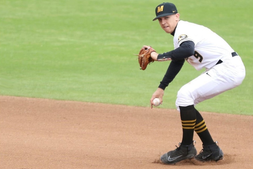 University of Missouri baseball player Robbie Glendinning prepares to throw a ball fielded from the infield.