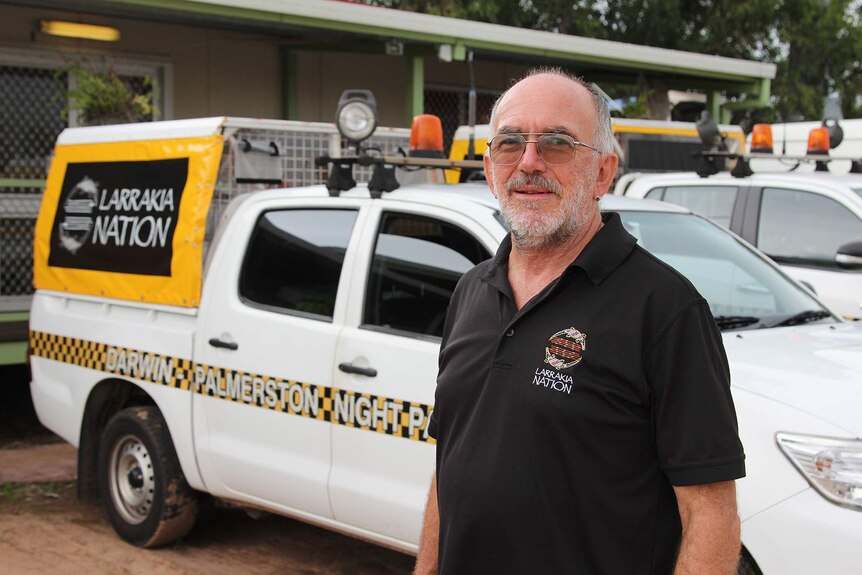 Larrakia Nation Aboriginal Corporation CEO Robert Cooper stands in front of a night patrol van.