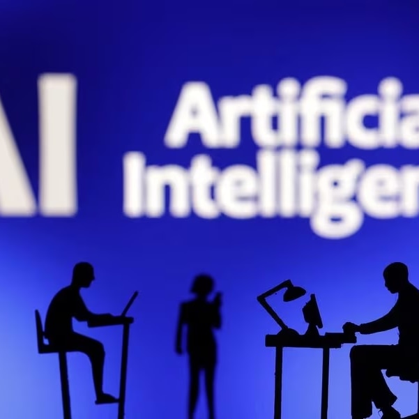 Figurines with computers and smartphones are seen in front of the words "Artificial Intelligence AI" in this illustration.