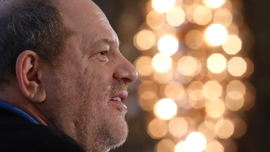 Close up of a man's face with lights shimmering in the background