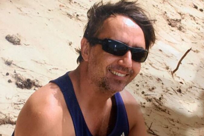 David Murphy sits on a beach wearing sunglasses, date and location unknown.