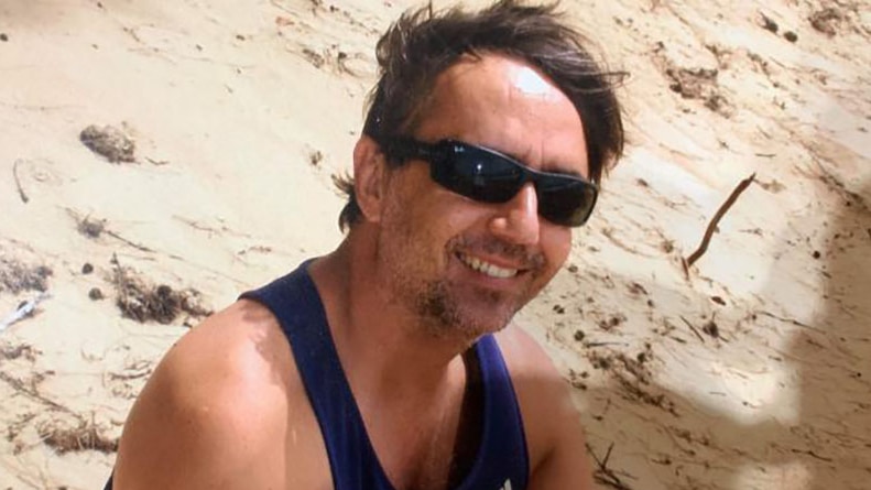 David Murphy sits on a beach wearing sunglasses, date and location unknown.