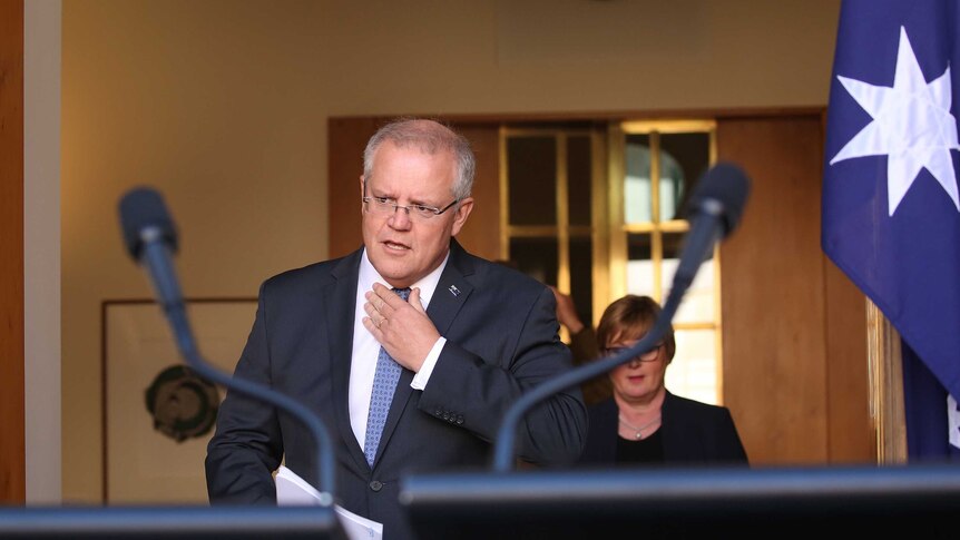 Prime Minister Scott Morrison adjusts his tie
