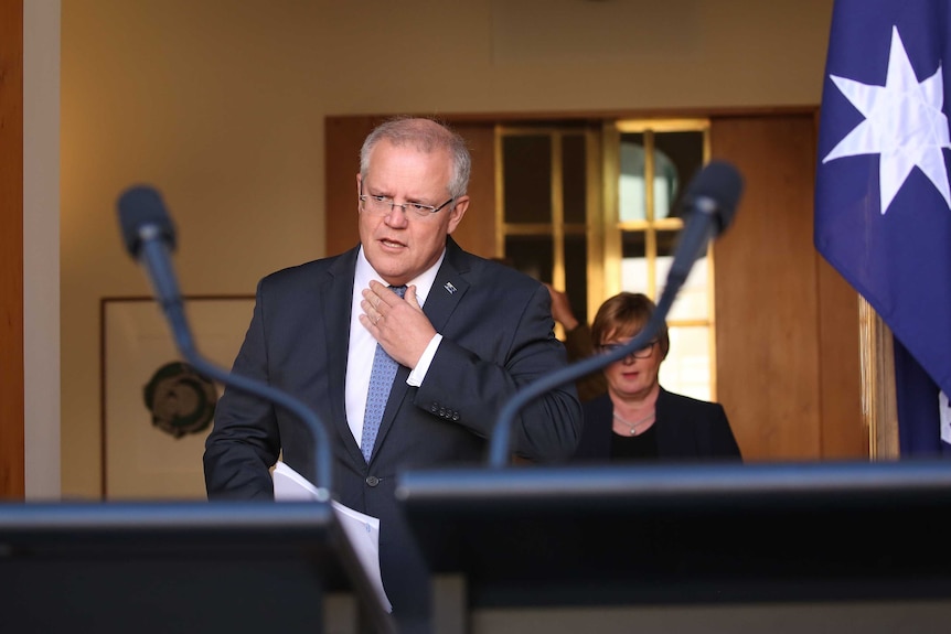 Prime Minister Scott Morrison adjusts his tie