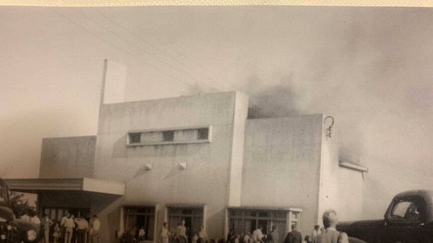 Exterior of the Valley theatre, smoke coming out of the roof the building, fire trucks in foreground