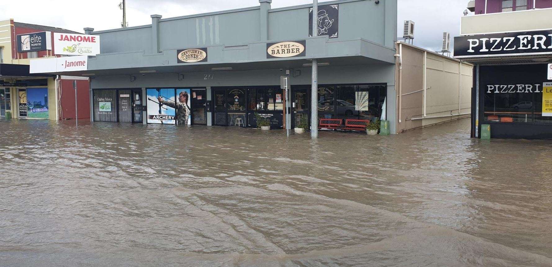 Townsville businesses flooded as burst water main inundates street