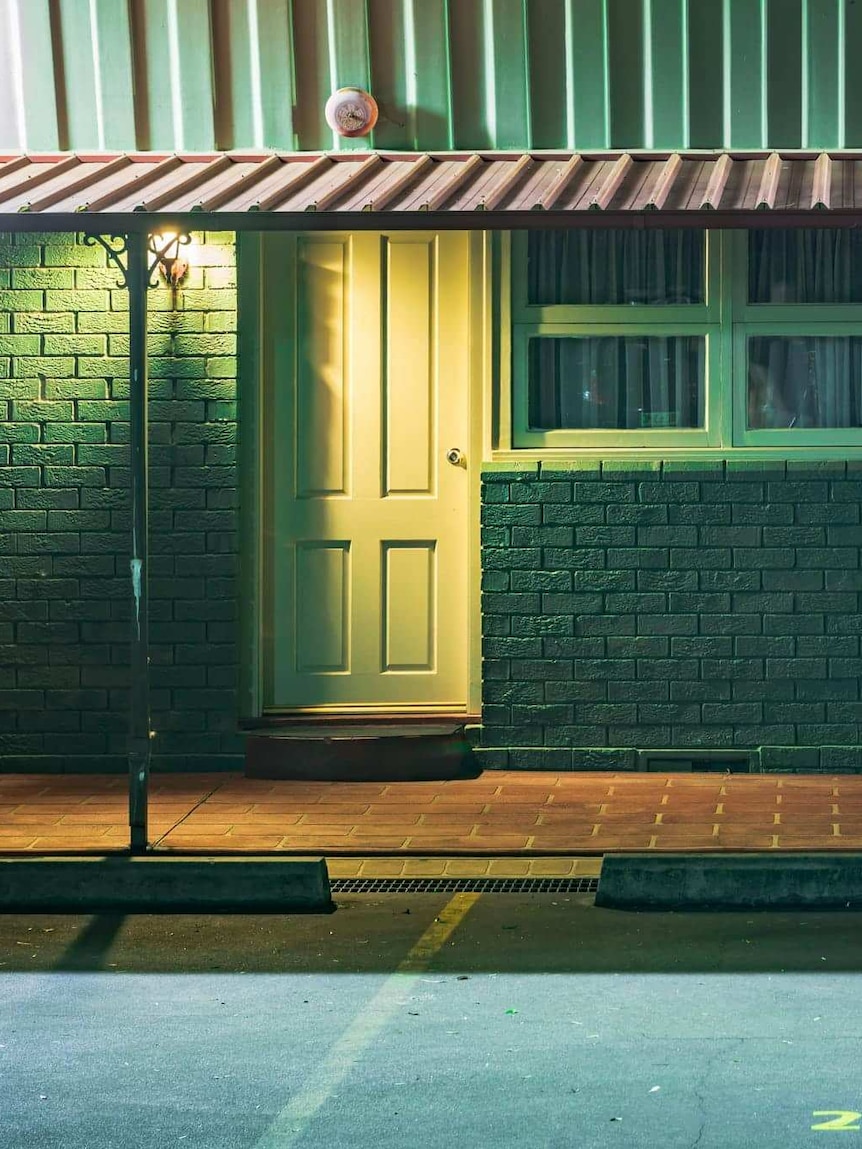 The front doors and windows of a budget motel.