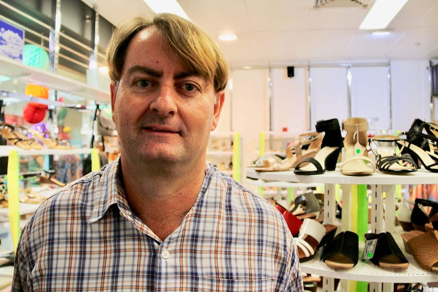 Broadbeach shoe shop owner Grayson Pearse stands in his business on the Gold Coast on April 8, 2018