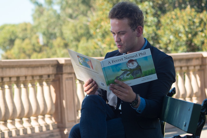 William Reimer flicks through his book in Adelaide.