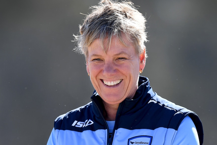 Jo Broadbent smiles while wearing a blue jacket
