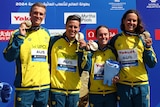 Australia's open-water relay team show off their gold medals at 2024 World Aquatics Championships.