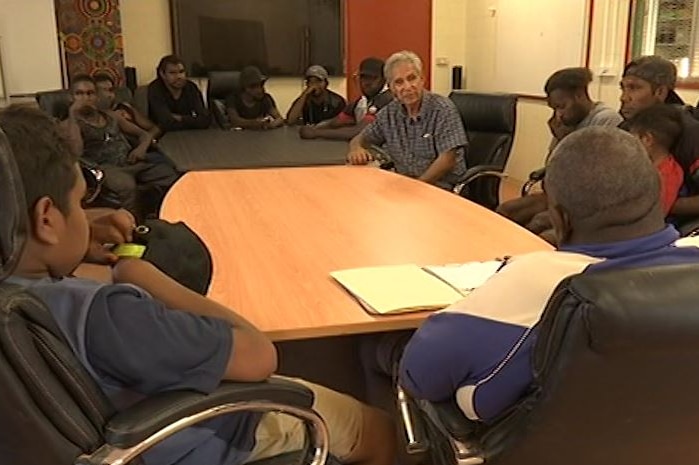 Charlie King speaks to a group of Indigenous men at the Ltyentye Apurte Football Club