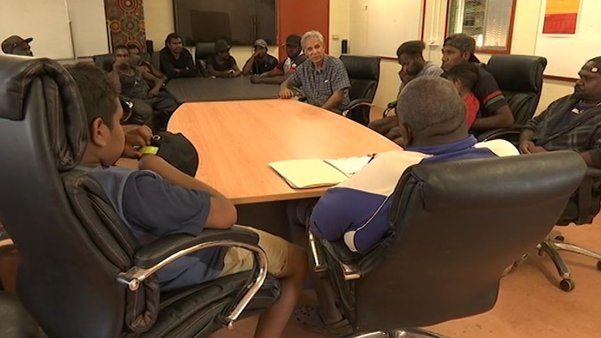 Charlie King speaks to a group of Indigenous men at the Ltyentye Apurte Football Club