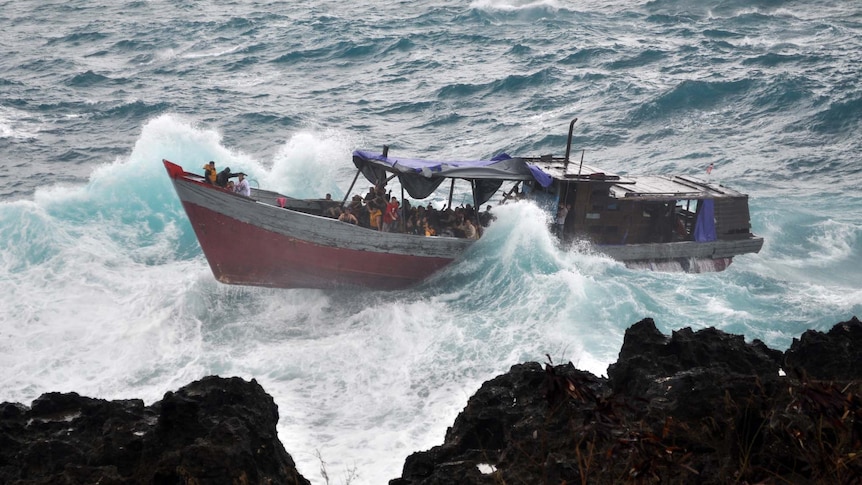 An asylum seeker boat is tossed in heavy seas off Christmas Island