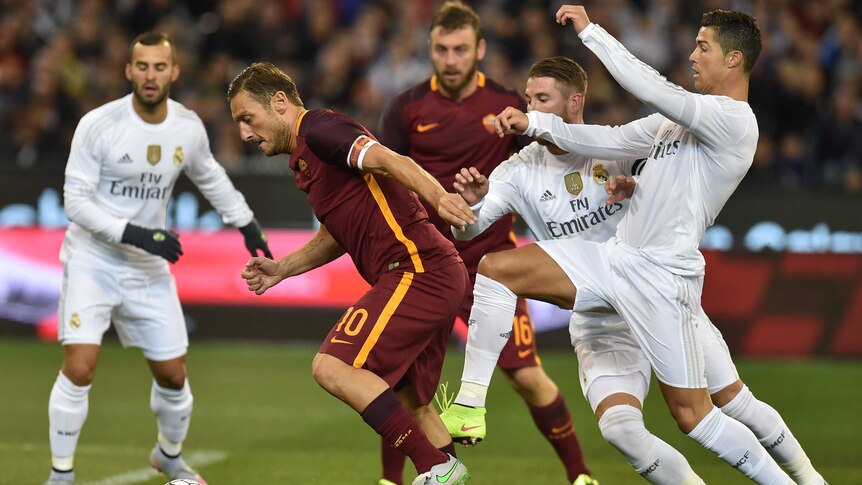 Cristiano Ronaldo tackles Francesco Totti