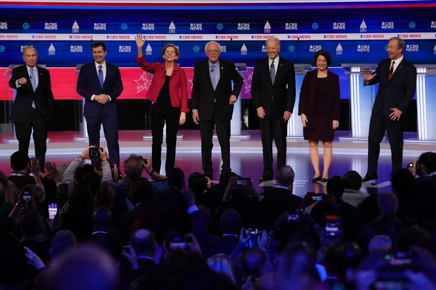 Candidates at the 2020 Democratic debate line up on stage in front of a crowd.