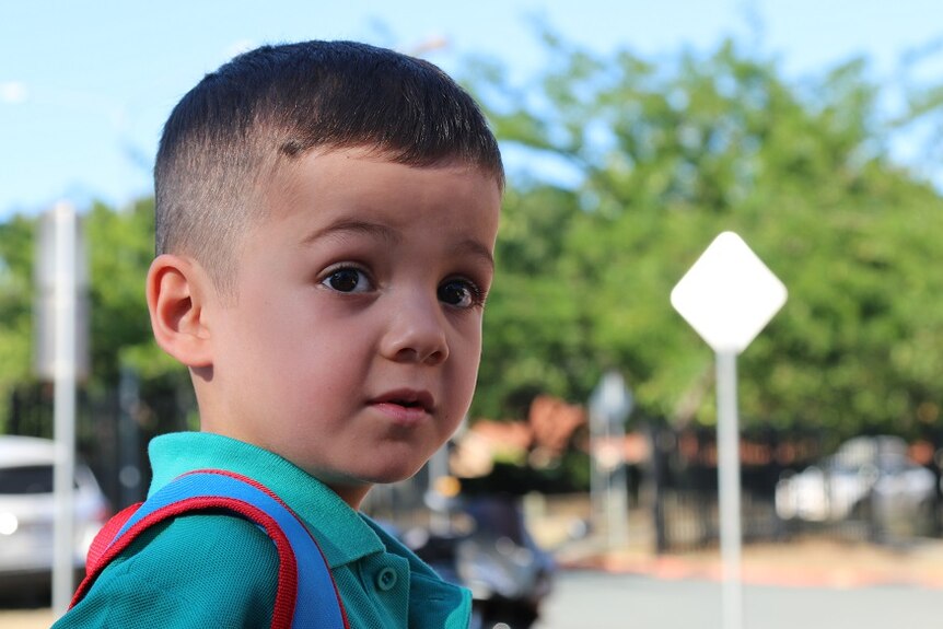 A photo portrait of Elijah on his first day of kindergarten.